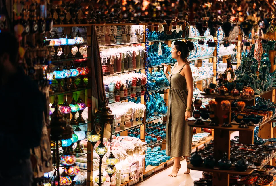 Shopper browsing a souvenir shop lined with gifts