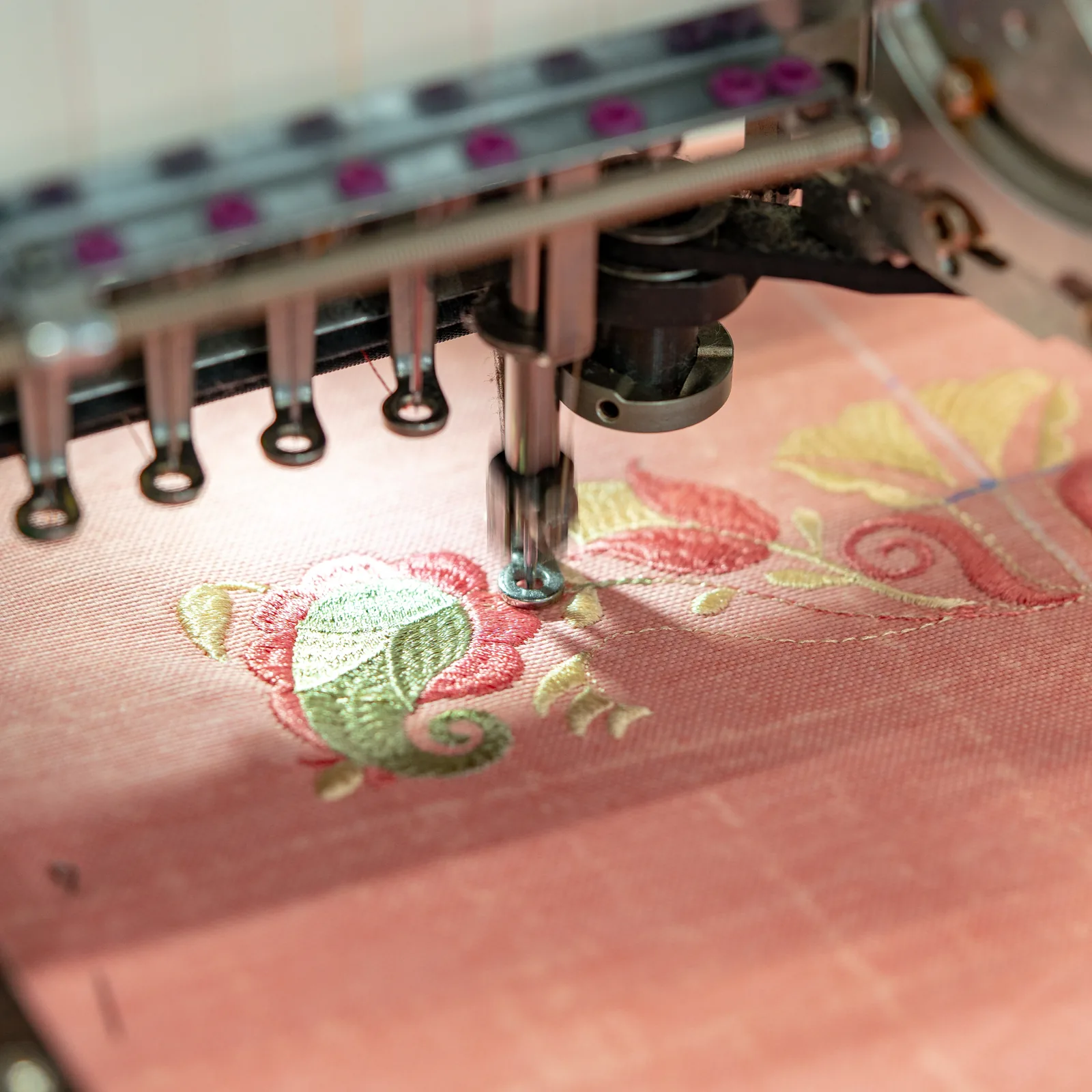 Embroidery machine stitching a design onto fabric