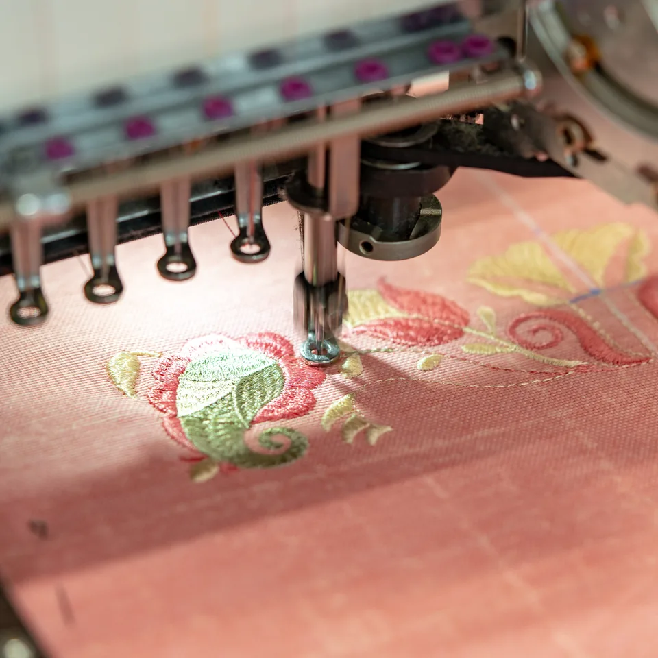 Embroidery machine stitching a design onto fabric